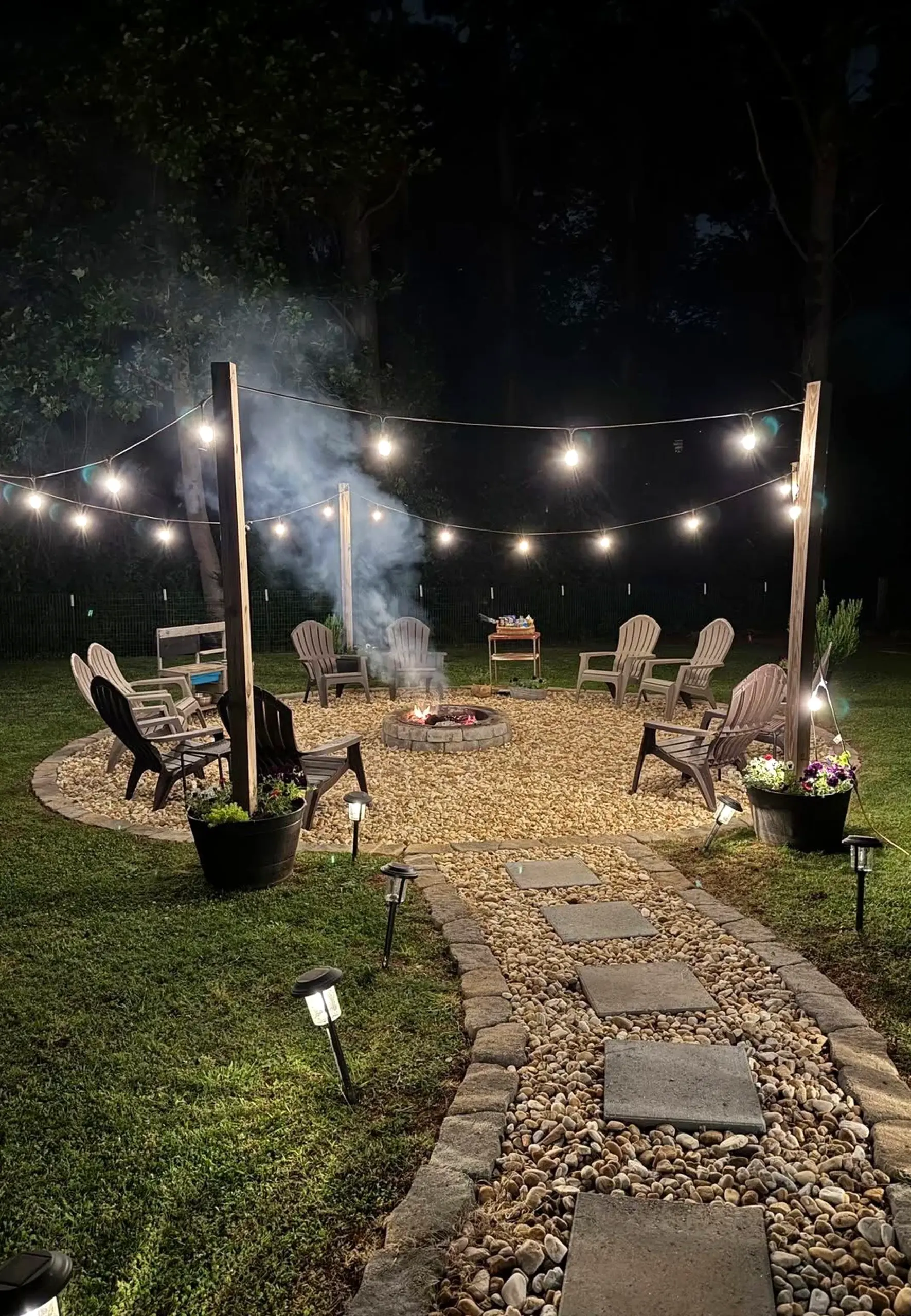 Warm balcony scene anchors the garden edge with movement, giving the view a mood that feels comfortable in daily use.