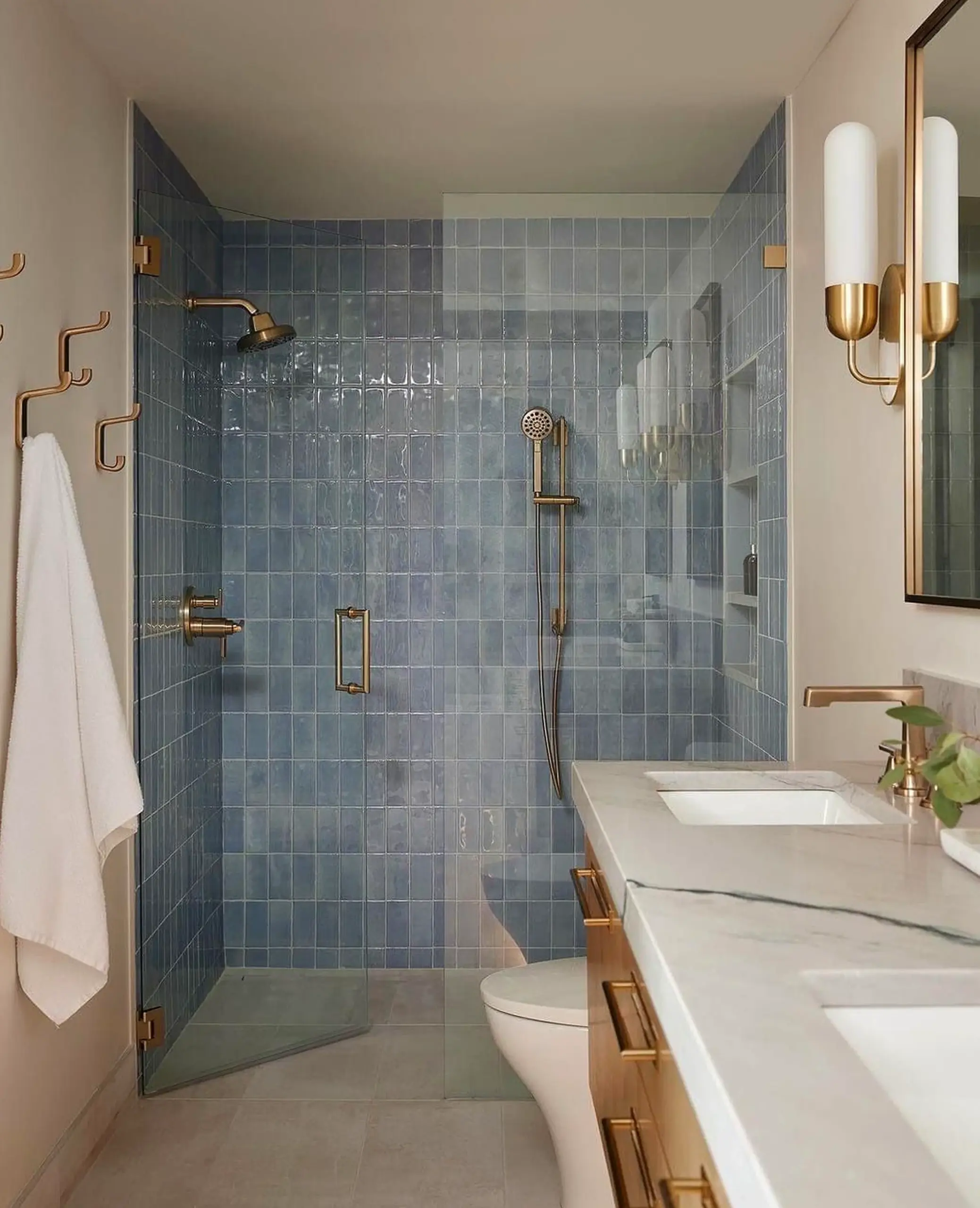 Sculptural shower wall frames the setting with shape, making the scene feel personal and relaxed.