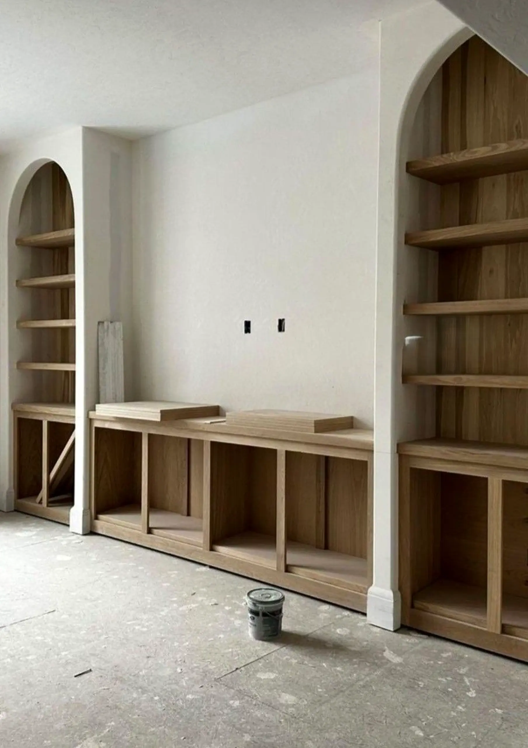 Airy wood shelving draws attention to shape while the composition stays ready for quiet use.