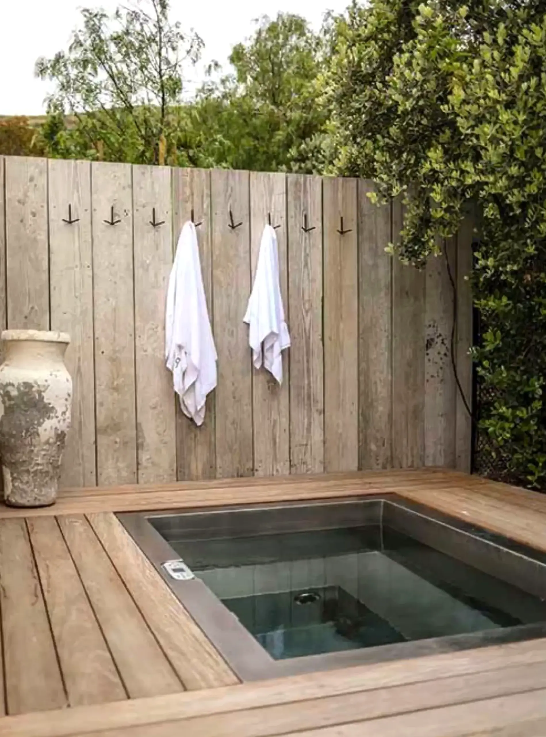 Relaxed porch bench supports the setting through contrast, leaving the space feeling quietly finished.
